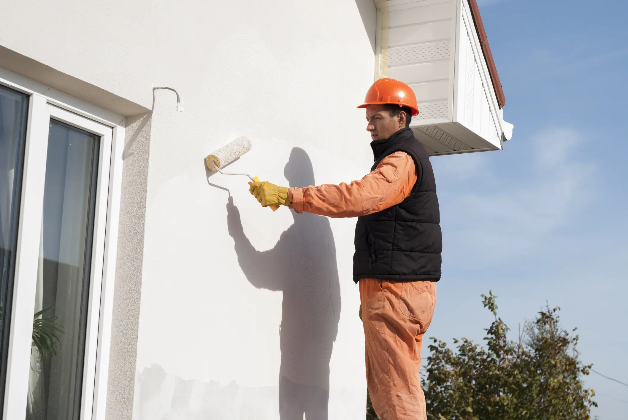 worker is painting a wall